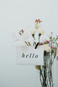 A bouquet of delicate flowers accompanies a welcome note with